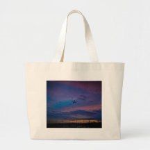 Avión sobre cielo multicolor bolsas lienzo