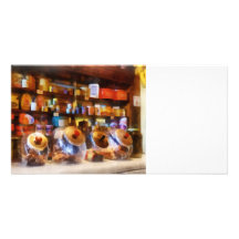 Cuatro tarros de cristal del caramelo tarjeta fotográfica