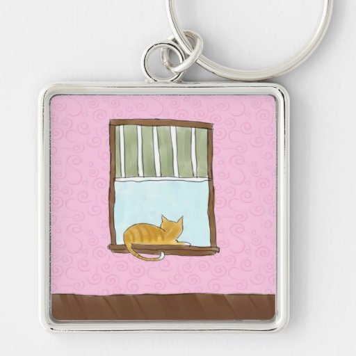 Gatito amarillo en un llavero de la ventana