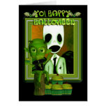 Imp verde de Halloween que se sienta en un registr Felicitacion