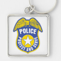 La policía protege y sirve la insignia llaveros