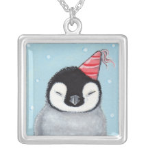 Polluelo del pingüino en un colgante del gorra del