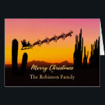 Add A Name Christmas Santa Over Desert<br><div class="desc">A Christmas card for you to customize by adding the name of the person or family that you are sending the card to. The card shows Santa flying over the desert. Lots of tall cactus are seen in silhouette. Wish a merry Christmas from the desert with a lovely sunset colored...</div>