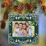 Adorno De Cerámica 2 Fotos Navidades de la familia de la vegetación d<br><div class="desc">Este adorno navideño cuadrado y oscuro presenta un elegante ilustracion verde de invierno blanco que enmarca la foto horizontal. El diseño ofrece espacio para 2 fotografías,  una en la parte delantera y otra en la parte trasera. Personalice este adorable adorno de conservas con su nombre familiar y el año.</div>