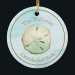 Adorno De Cerámica Acuarela Sand Dollar Beach Name & Aniversario<br><div class="desc">Celebra tu primera Navidad y todas las Navidades a seguir con este adorno conmemorativo. Personalice con su nombre y aniversario o año establecido con las plantillas de texto fáciles de usar. Encuentra productos que coincidan en mi colección de bodas de arena en dolar.</div>
