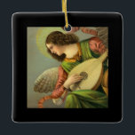 Adorno De Cerámica Angel Painting With Mandolin<br><div class="desc">beautiful renascence style vintage painting of an angel with brown curly hair, wings, halo, shiny pink ribbon, wearing a lovely pink shirt, lovely green dress with gold collar, and beautiful graceful hands with fingers strumming a mandolin placed on her lap, and she seems to be standing above and looking out...</div>