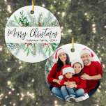 Adorno De Cerámica Elegant Botanical Greenery Photo Merry Christmas<br><div class="desc">This simple and classic round Christmas ornament features elegant greenery on the front, including evergreen branches, soft leaves, and subtle pops of red holly berries for a festive touch. In the center, “Merry Christmas” is written in graceful script typography, with space below for your family name or business name. The...</div>