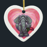 Adorno De Cerámica Elephant El día de San Valentín<br><div class="desc">Desfile Animal Elefante Romántico Amor y Corazones Regalos y Accesorios del Día de San Valentín presenta nuestra divertida obra de arte de un tierno elefante sosteniendo a una rosa en la boca con sus corazones púrpura, rojo y rosado estratificados detrás de ella creada por nuestro talentoso artista, Traci Van Wagoner....</div>