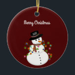 Adorno De Cerámica Feliz Navidad a Snowman personalizado<br><div class="desc">El muñeco de nieve lindo está enredado con luces de Navidades iluminadas, tiene el año en su gorra - el texto de "Feliz Navidad" de arriba puede ser cambiado o agregado, y el estilo/tamaño del tipo de letra también puede ser cambiado. Se muestra en un fondo rojo profundo, que puede...</div>