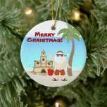 Adorno De Cerámica Feliz Navidad personalizada de Santa Beach<br><div class="desc">Festividad personalizada en Santa Beach Ornamento navideño con palmeras decoradas,  un castillo de arena y adornos de vacaciones. Algunos gráficos de artwork&@delightful-doodles.com. *</div>