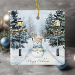 Adorno De Cerámica Festividades de Snowman<br><div class="desc">Ornamento festivo de Navidades con un muñeco de nieve de acuarela centrado en el fondo invernal de una carretera arbolada con lámparas de calle adornadas con luces blancas. Feliz feriado saludo debajo de snowman. Existen tamaños y estilos adicionales disponibles. Es posible que la imagen necesite ser alterada para diferentes tamaños....</div>