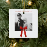 Adorno De Cerámica Foto de Cute Red Bow Ferry Christmas<br><div class="desc">Un adorno navideño lindo con un diseño simple y minimalista con un arco rojo sobre el fondo de tu foto cuadrada favorita. Arriba está el saludo "Feliz Navidad".</div>