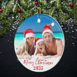 Adorno De Cerámica Fotos de la familia Sunny de Feliz Navidad<br><div class="desc">Un adorno de dos caras de un árbol de navidad con una foto de tu elección en la parte delantera y trasera, con un guión rojo estacional en ambos lados. Para cambiar o borrar el texto y la foto en cualquiera de los lados o en ambos lados, haga clic en...</div>