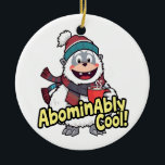 Adorno De Cerámica Inominable Guay Winter Yeti Design<br><div class="desc">Un alegre yeti disfrutando del invierno con una bufanda y cacao caliente,  acompañado por la lúgubre frase "¡Abominablemente Guay!"</div>