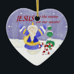 Adorno De Cerámica Jesús es la razón de nuestra temporada Ornament<br><div class="desc">¡Un placer para mantener el foco de la temporada en la que pertenece! El arte utilizado para crear este maravilloso y a la vez significativo adorno navideño fue creado a partir de pinturas de color acuático a mano de Audrey Jeanne Roberts. Este adorno tiene un adorador muñeco de nieve, un...</div>