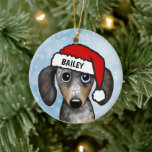 Adorno De Cerámica Merle Dapple Dachshund Nombre Personalizado<br><div class="desc">Un adorable adorable adorno navideño del rucio Dachshund que puede ser personalizado con tu propio texto. Añade un nombre para un regalo de personalizado divertido. Hace un adorable ornamento para exhibirlo en el árbol de Navidad en los años por venir. Visite el mundo doodle de Jenn para ver más regalos...</div>