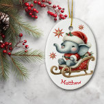Adorno De Cerámica Navidades Cute Santa Elephant Sleigh Kids<br><div class="desc">Delante de este adorable adorno navideño de niños adorables hay un oso panda sentado en un trineo rojo y dorado. Lleva un sombrero de Santa y blanco y un traje de santa. Las estrellas decorativas rojas y doradas están dispersas por todo el hotel, y tu nombre personalizado está en la...</div>