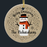 Adorno De Cerámica Navidades de invierno sucios Snowman<br><div class="desc">Un lindo muñeco de nieve Navidad con las palabras Feliz Navidad decora este adorno. Personalízalo con tu apellido. Un acento divertido para la temporada de Navidades. Diseñado para ti por Blackberry Boulevard.</div>