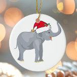 Adorno De Cerámica Navidades Fiesta elefante blanco<br><div class="desc">Los animales vacacionales son mi parte favorita de los Navidades. Un bello elefante con un sombrero rojo de Papá Noel y que se ve feliz. Esto me llena del espíritu Navidad.</div>