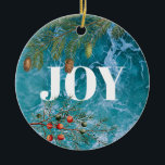 Adorno De Cerámica Navidades Summer Ocean Beach Joy<br><div class="desc">Las profundas olas azules del océano en el fondo con coníferas y bayas de Navidades enmarcando la palabra "JOY". Un hermoso diseño costero con temática navideña ideal para Navidades en las celebraciones de verano o Navidades costeros.</div>