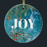 Adorno De Cerámica Navidades Summer Ocean Beach Joy<br><div class="desc">Las profundas olas azules del océano en el fondo con coníferas y bayas de Navidades enmarcando la palabra "JOY". Un hermoso diseño costero con temática navideña ideal para Navidades en las celebraciones de verano o Navidades costeros.</div>