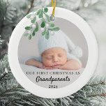 Adorno De Cerámica Nuestra primera Navidad como abuelos foto de folla<br><div class="desc">El primer ornamento de Navidad de este abuelo está decorado con mistletoe de color verde agua. Personalizable fácil con la foto, nombre y año de su bebé. Utilice la Herramienta de diseño para cambiar el tamaño, estilo o color del texto. Porque creamos nuestra obra de arte no encontrarás esta imagen...</div>