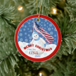 Adorno De Cerámica Patriotic Snowman and Flag Christmas Ornament<br><div class="desc">Cute little snowman and American flag in a flurry of snowflakes on a holiday USA Christmas keepsake ornament. Will bring a smile to the heart and fond memories to our military service men and women. A perfect gift to show how much we care and honor their service. Personalize by adding...</div>