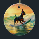 Adorno De Cerámica Pintura Doberman Beach Surfing<br><div class="desc">Sumérgete en el mundo lúdico de la aventura canina con esta pintura cautivadora. Un perro animado lleva a las olas, subiendo con habilidad al surf en una playa con sol. El vibrante arte captura bellamente la esencia de la emoción en la playa mientras el perro recorre sin miedo las olas,...</div>