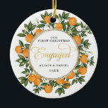 Adorno De Cerámica Primera Navidad Boda involucrado Citrus Greenery<br><div class="desc">Este adorno navideño inspirado en los cítricos presenta hermosos naranjas pintados a mano y una exuberante vegetación. ¡Genial para un boda de verano! Los campos de texto son completamente editables excepto para la palabra "Engaged" (Involucrado). Simplemente elimine esta palabra haciendo clic en el botón borrar y agregue su propio texto...</div>