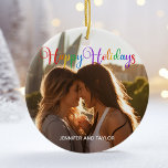 Adorno De Cerámica Rainbow Happy Holidays LGBTQ Couple Photo<br><div class="desc">Elegante foto de Happy Holidays adornada con hermosa tipografía cursiva arcoiris. Este moderno regalo de fotografía de pareja de feriados LGBTQ incluye un magnífico guión y tu nombre en blanco sobre la imagen completa de una pareja LGBT. Personaliza este adorable adorno navideño con tu fotografía favorita.</div>