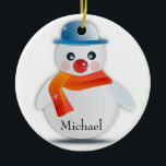 Adorno De Cerámica Snowman Ornament<br><div class="desc">Feliz y festivo muñeco de nieve para decorar tus vacaciones. Personalizar reemplazando "Michael" por cualquier nombre. Diseño creado por Black Brook Photography con un gráfico de Pixabay en setiembre de 2014.</div>