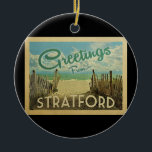 Adorno De Cerámica Viaje de Vintage de Stratford Beach<br><div class="desc">El diseño de esta postal antigua de Greetings From Stratford incluye una playa de arena con un hermoso agua turquesa del océano y sobre el mar,  un cielo azul con nubes blancas onduladas. En estilo de viajes vintage.</div>