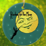 Adorno De Cerámica Vintage Winter Moon Man Ladder llega a la luna<br><div class="desc">Esta imagen vintage tiene una gran luna sonriente amarilla con cara. Un hombre con traje sube una escalera de bata a la luna. El texto dice "Llegar a la luna en un verde con brillantes estrellas". Vea mi tienda Arte de MAR para encontrar productos que coincidan con este diseño.</div>