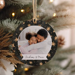 Adorno De Cerámica Winter Stars Double Sided Personalized Photo<br><div class="desc">A sweet double sided photo ornament displaying a favorite photo on each side,  on a black watercolor background dotted with golden stars. Personalize with a custom caption on the front in handwritten lettering,  and add the year to the back.</div>