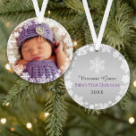 Adorno First Christmas Baby Girl Snowflake Frame Photo<br><div class="desc">Elegant snowflake framed baby's first Christmas photo ornament design features a round border wreath of white winter snowflakes that frame the baby girl's newborn photo. A custom "Baby's First Christmas" message appears on the back with text the can be personalized with baby boy's name and birth year. The silvery gray...</div>