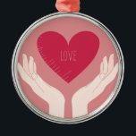Adorno Metálico El corazón rojo ama al El día de San Valentín romá<br><div class="desc">diseño romántico de un corazón rosa brillante con la palabra amor en el medio y dos manos sosteniendo el corazón contra un fondo rosa rubor. Este bonito diseño elegante de chicas es perfecto para el día de San Valentín o cualquier otra ocasión romántica.</div>