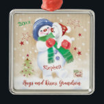 Adorno Metálico Grandson, Christmas Snow Boy Hugs Puppy<br><div class="desc">For your Grandson at Christmas. An adoreable little snow child carrying his snow puppy is the cute illustration on this sweet Christmas ornament for Grandson. The little snow boy wears a blue wooly hat and green scarf. The tiny snow puppy in a red Santa hat seems to be licking his...</div>