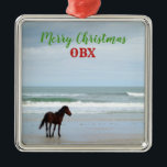 Adorno Metálico Wild Horse Corolla Outer Banks OBX<br><div class="desc">This beautiful Christmas ornament features a wild horse of Corolla in the Outer Banks,  North Carolina.  The font,  color,  and wording of the text can be changed or even deleted to fit your preference.  Perfect for celebrating Christmas at your beach house or for anyone who loves the beach life!</div>