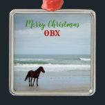 Adorno Metálico Wild Horse Corolla Outer Banks OBX<br><div class="desc">This beautiful Christmas ornament features a wild horse of Corolla in the Outer Banks,  North Carolina.  The font,  color,  and wording of the text can be changed or even deleted to fit your preference.  Perfect for celebrating Christmas at your beach house or for anyone who loves the beach life!</div>