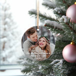 Adorno Nuestra primera foto de Boda moderno de Navidades<br><div class="desc">Elegante diseño de ornamento fotográfico para las vacaciones incluye tu imagen favorita de la pareja recién casada con el texto "Nuestros primeros Navidades casados" en letras modernas de escritura cepillada. Personalice el texto del personalizado con su apellido o apellido y el año. Un sencillo patrón de copos de nieve blancos...</div>