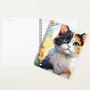 Agenda Gato de Calico en un jardín de primavera con marip