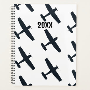 Agenda Guay, avión simple volando, negro y blanco