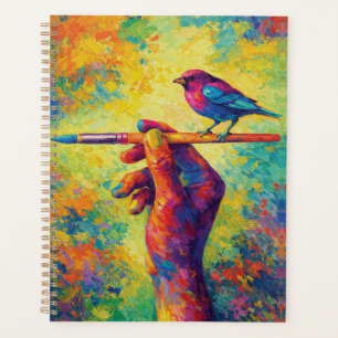 Agenda Mano sosteniendo pincel con ave creativa