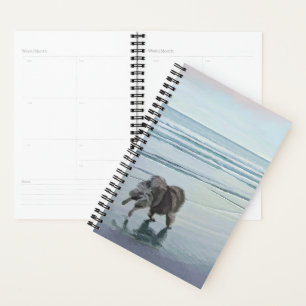 Agenda Manos en la pintura de perro en la costa