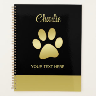 Agenda Paw dorada de perro brillante sobre fondo negro