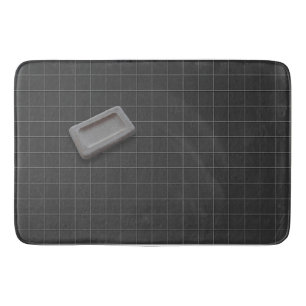 Alfombrilla De Baño Jabón de barra gris en suelo de mosaico negro