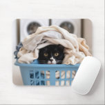 Alfombrilla De Ratón Tuxedo Cat Hiding in Laundry Basket<br><div class="desc">A black and white cat peeks out from under a pile of clothes in a blue laundry basket,  with two washing machines in the background,  enhancing the cozy scene</div>