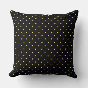 Almohada amarilla con lunares sobre negra