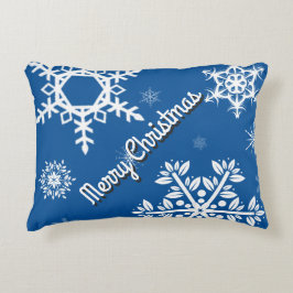 Almohada azul con copos de nieve blancos