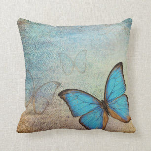 Almohada azul del vintage de la mariposa
